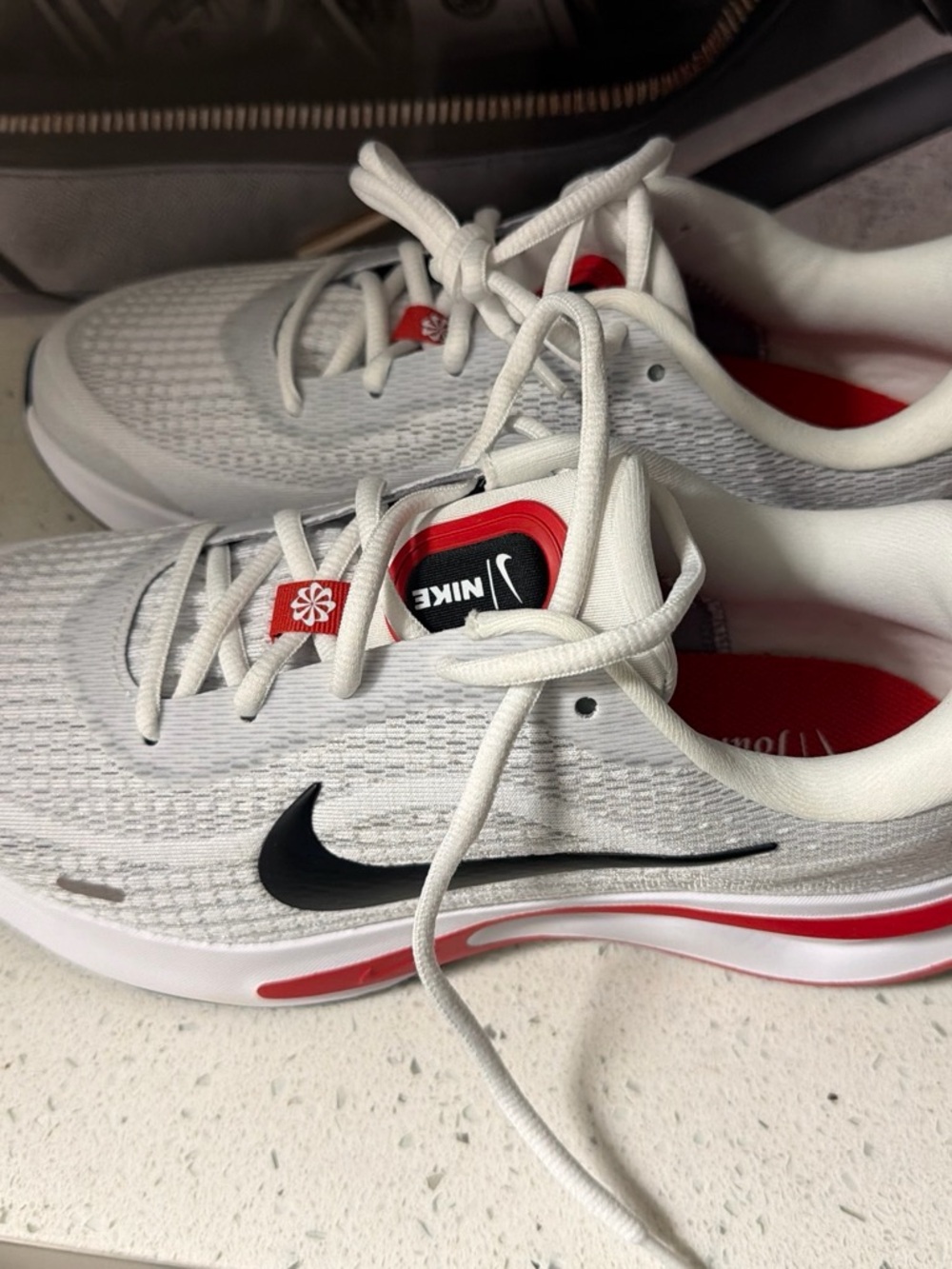 Nike Men's White Running Shoes with Black Swoosh and Red Accents